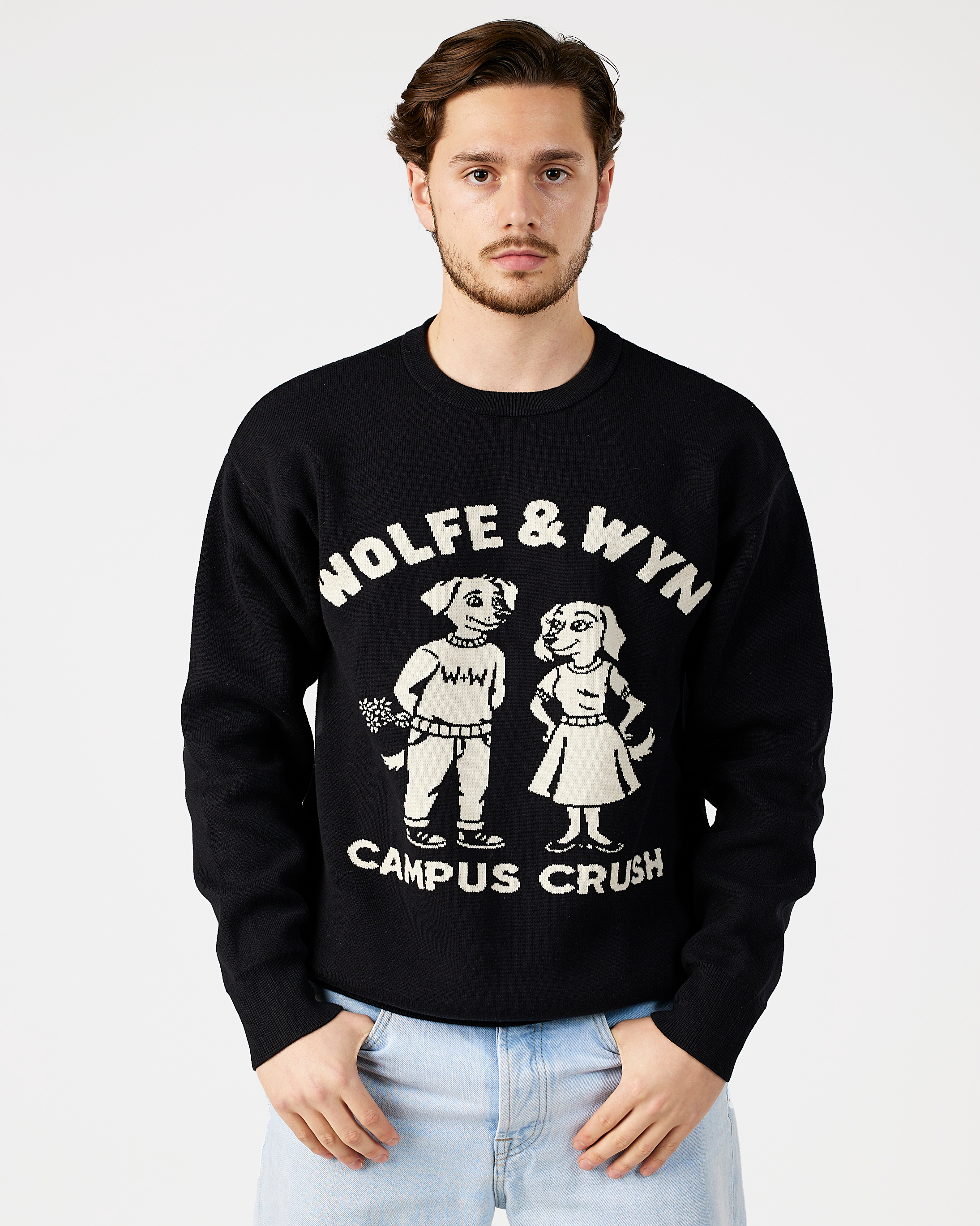 model wearing a black sweatshirt with 'Wolfe & Wyn Campus Crush' design on a plain background