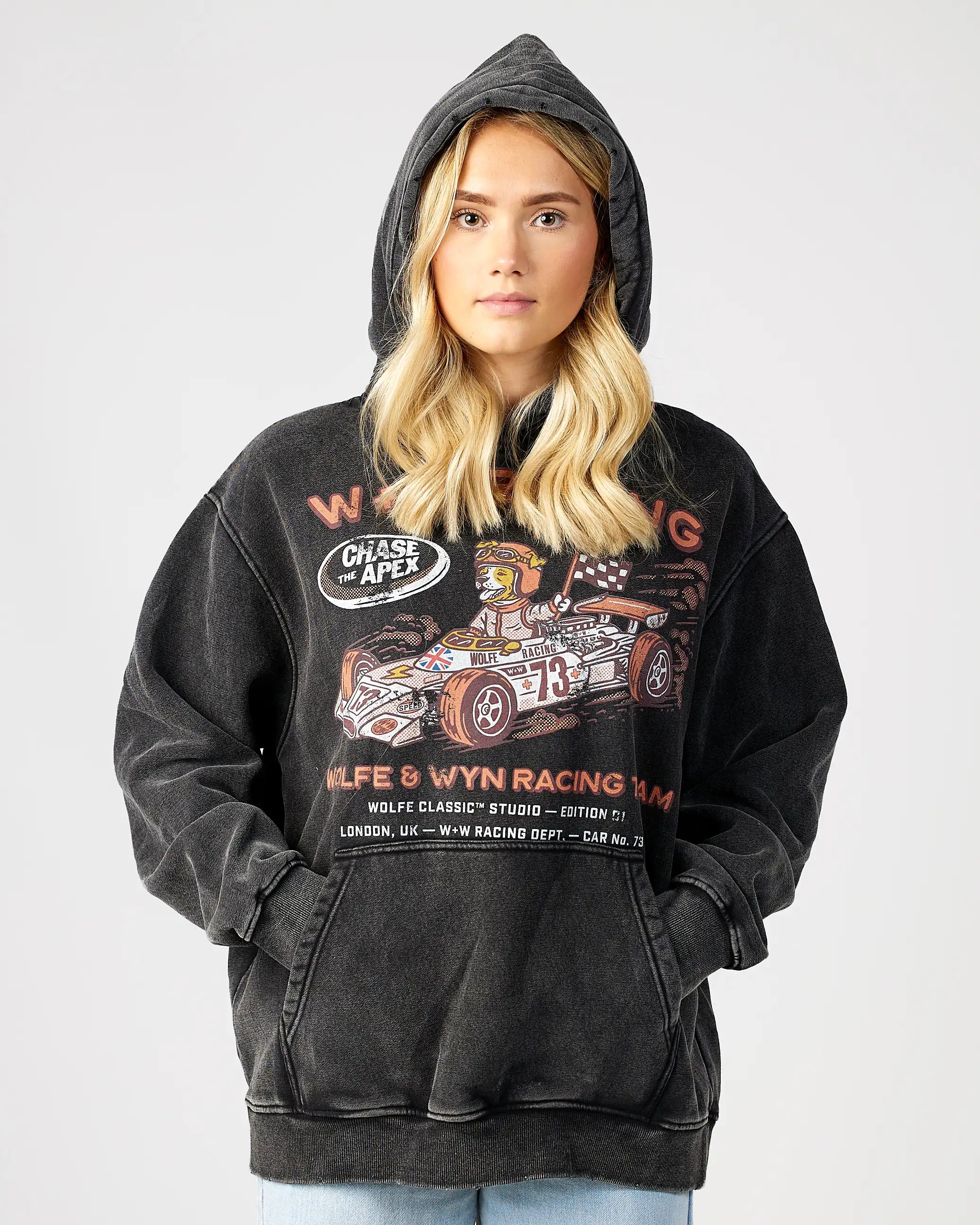 Person wearing a black hoodie with racing-themed graphics on a white background