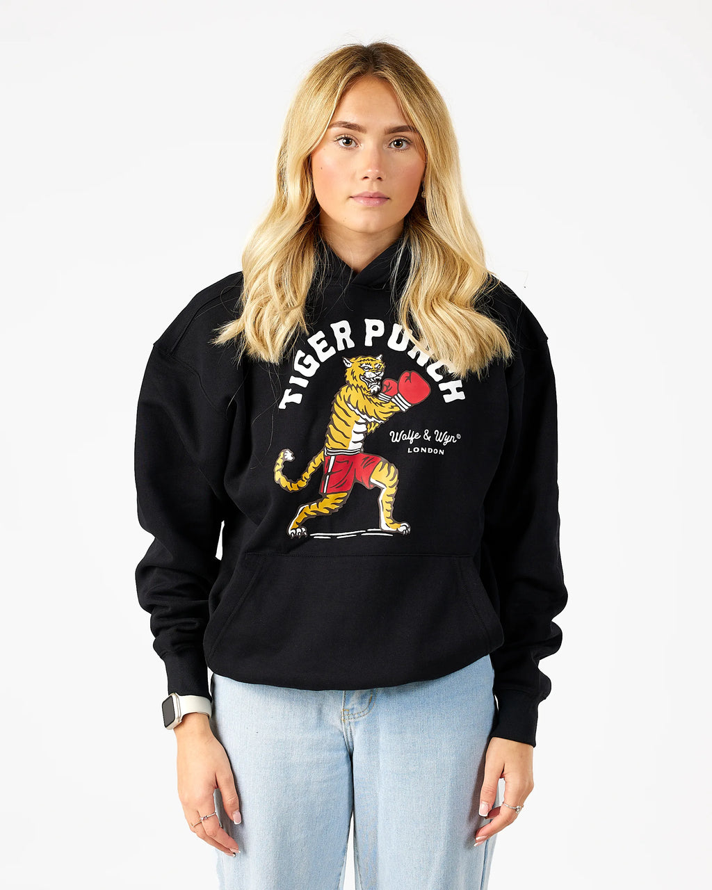 Person wearing a black hoodie with a tiger graphic and text on a white background
