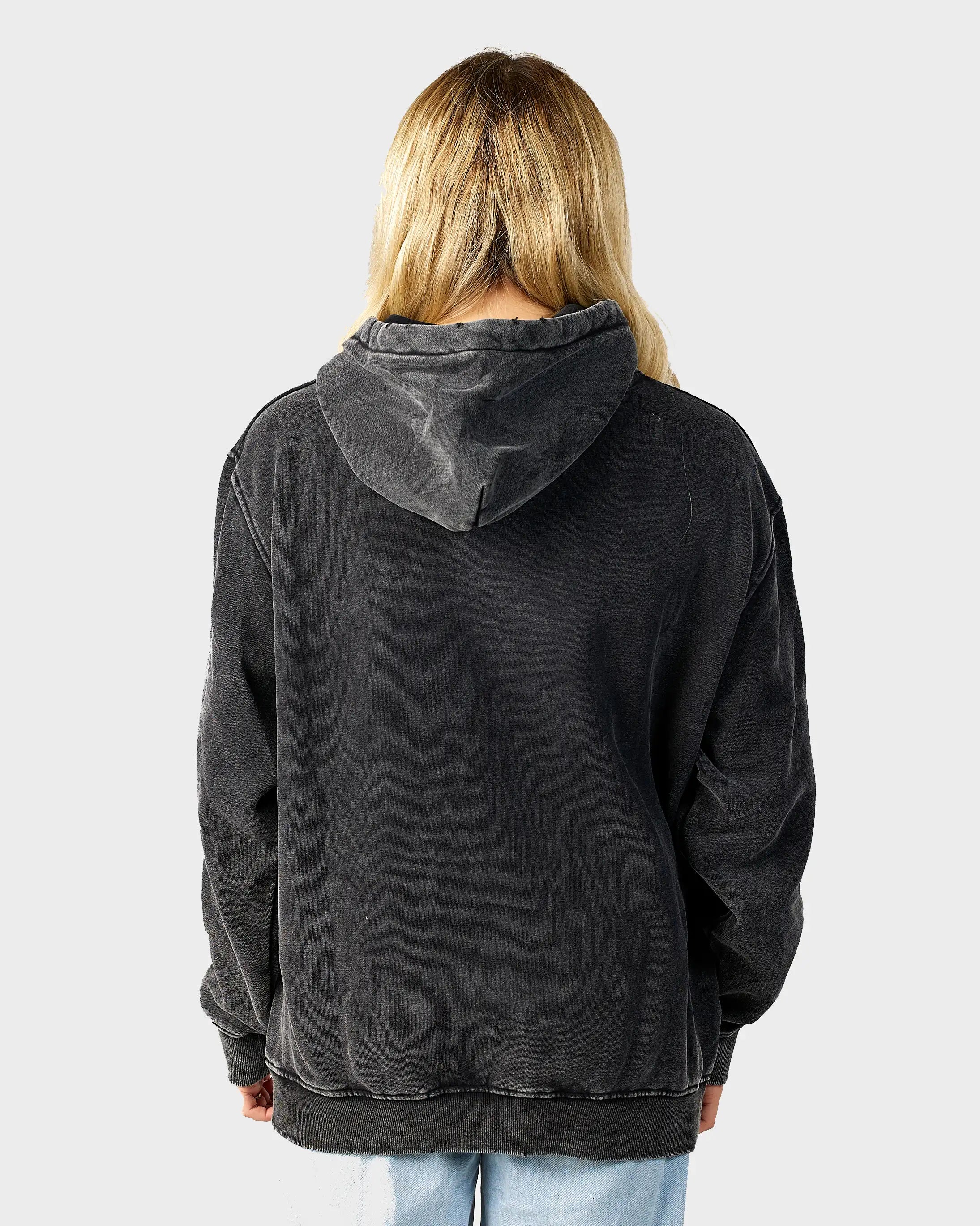 Person wearing a black hoodie from behind on a light gray background