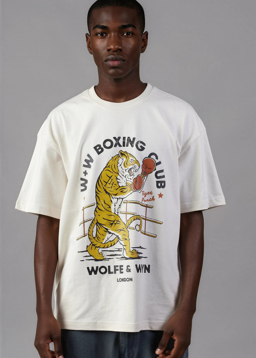 Person wearing a white t-shirt with a boxing-themed graphic design on a gray background
