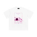 White t-shirt with pink graphic and text on a white background
