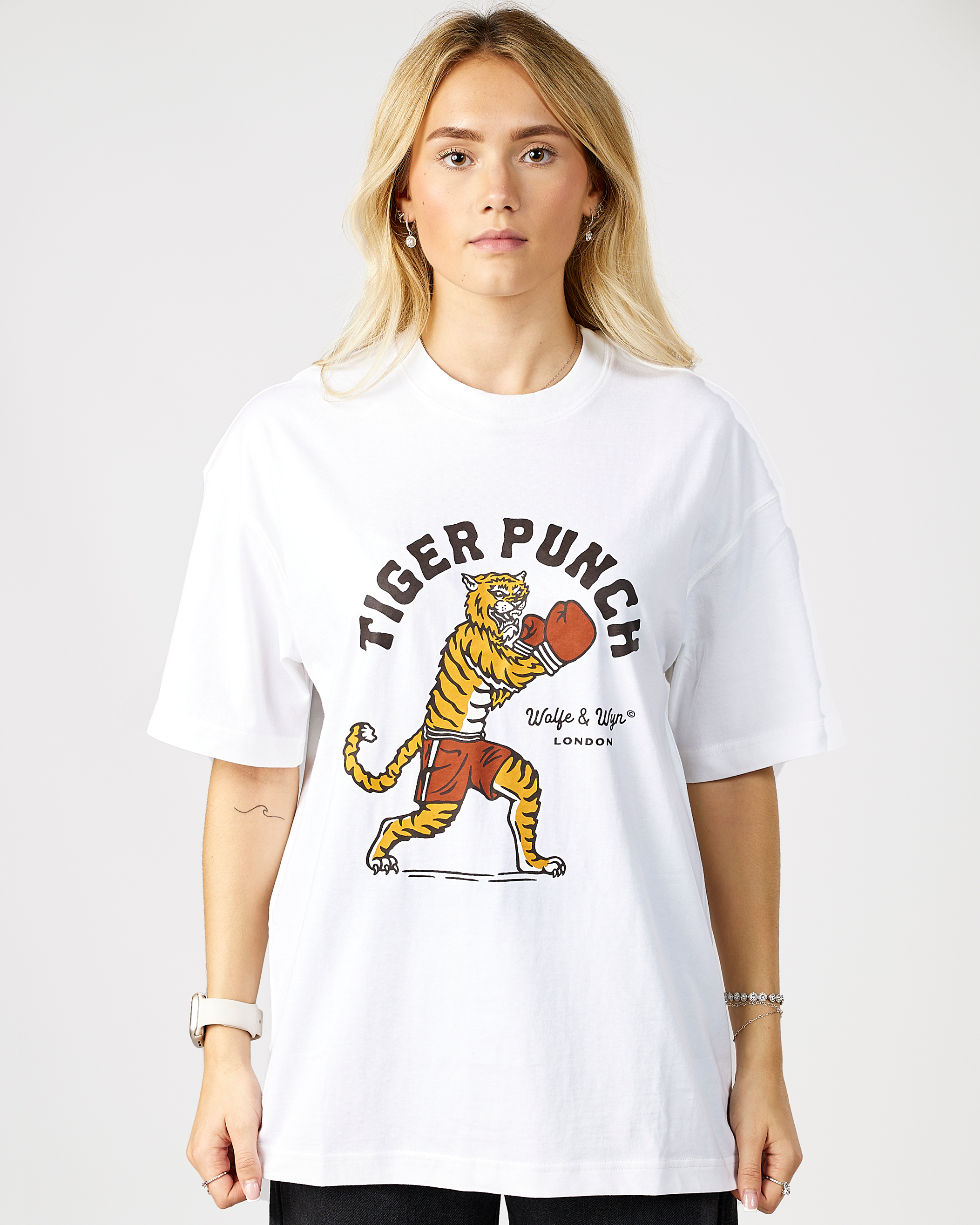 model wearing a white t-shirt with a tiger graphic and 'Tiger Punch' text on a plain background