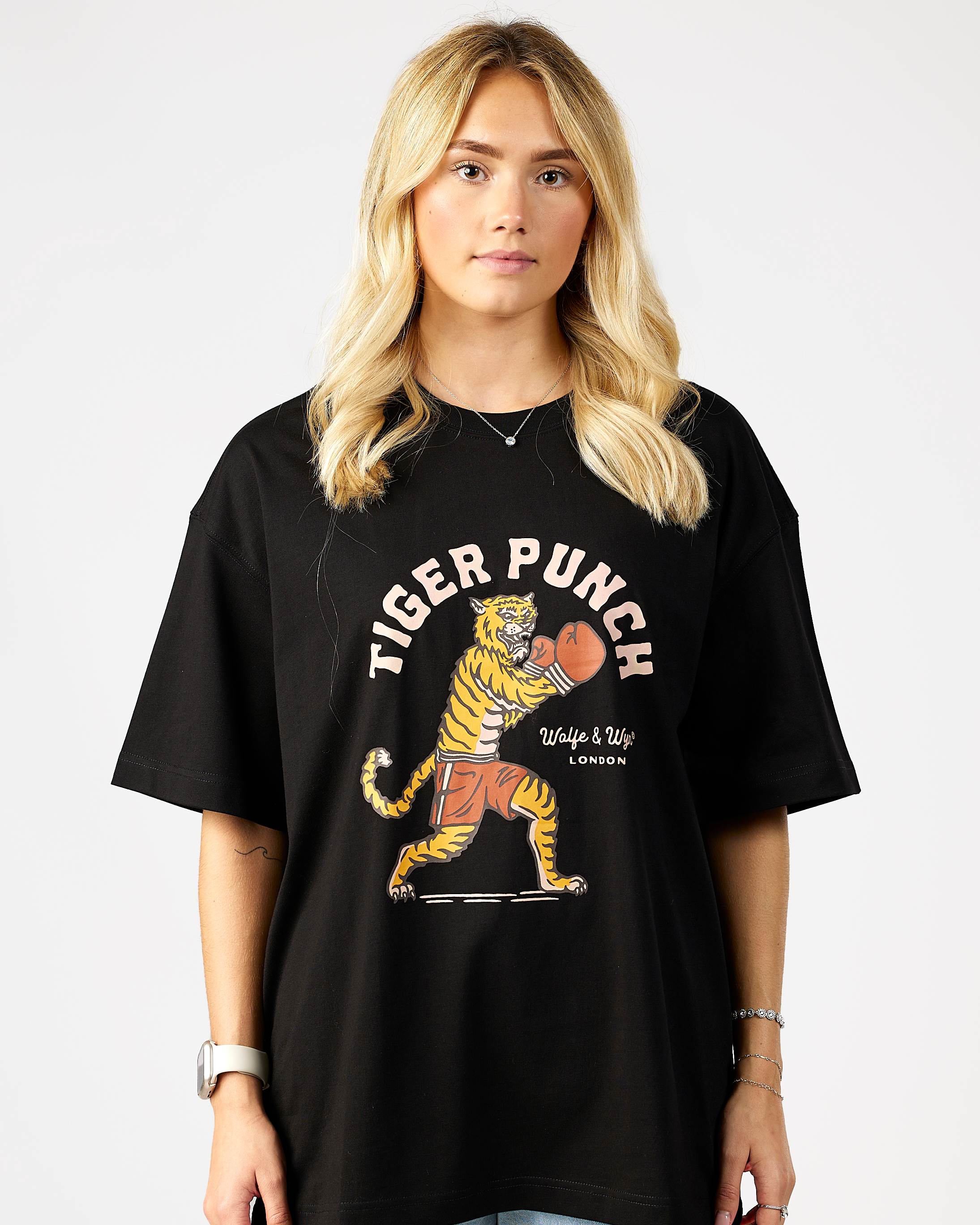 model wearing a black t-shirt with a tiger graphic and 'Tiger Punch' text on a plain background