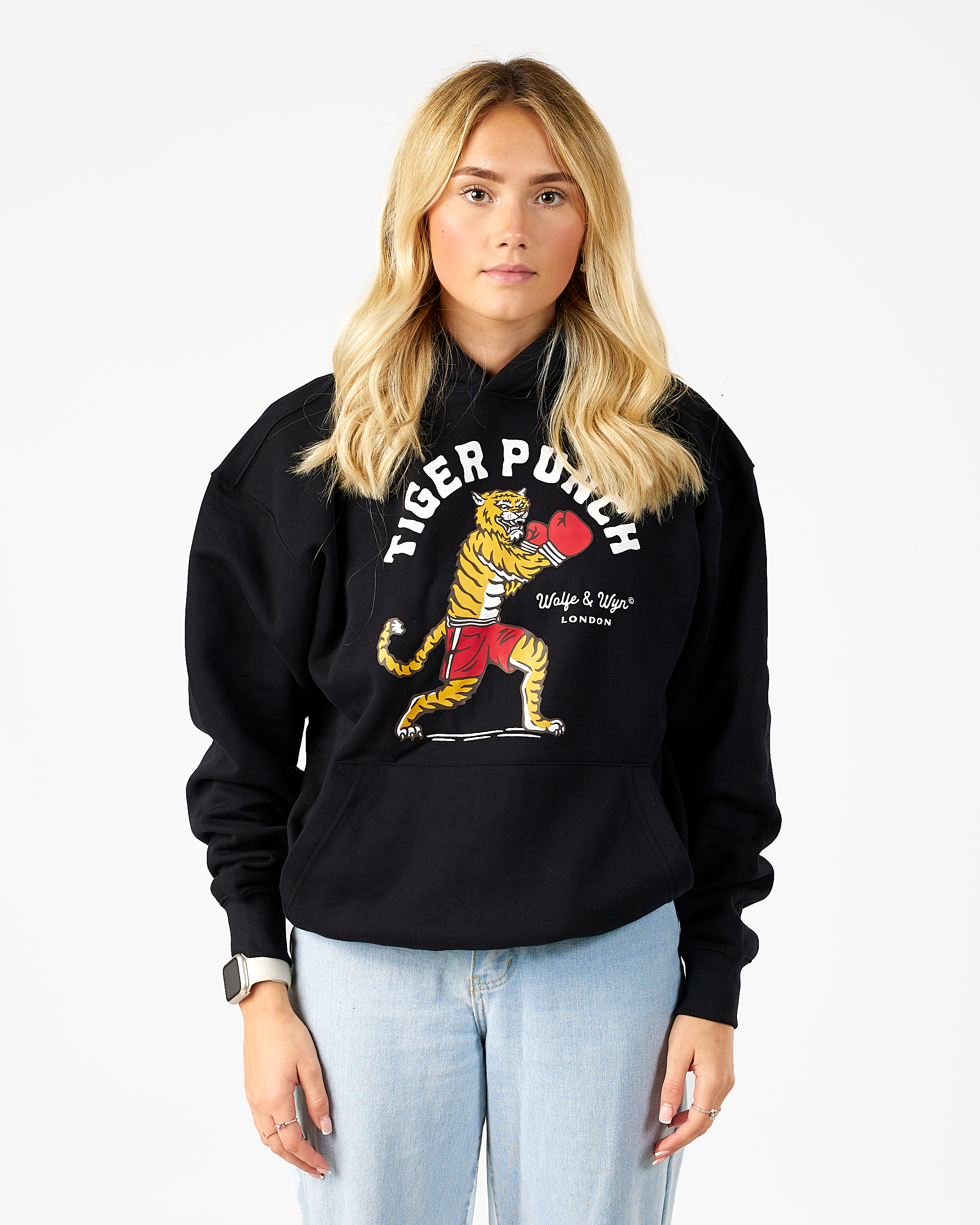 model wearing a black hoodie with a tiger graphic and text on a white background