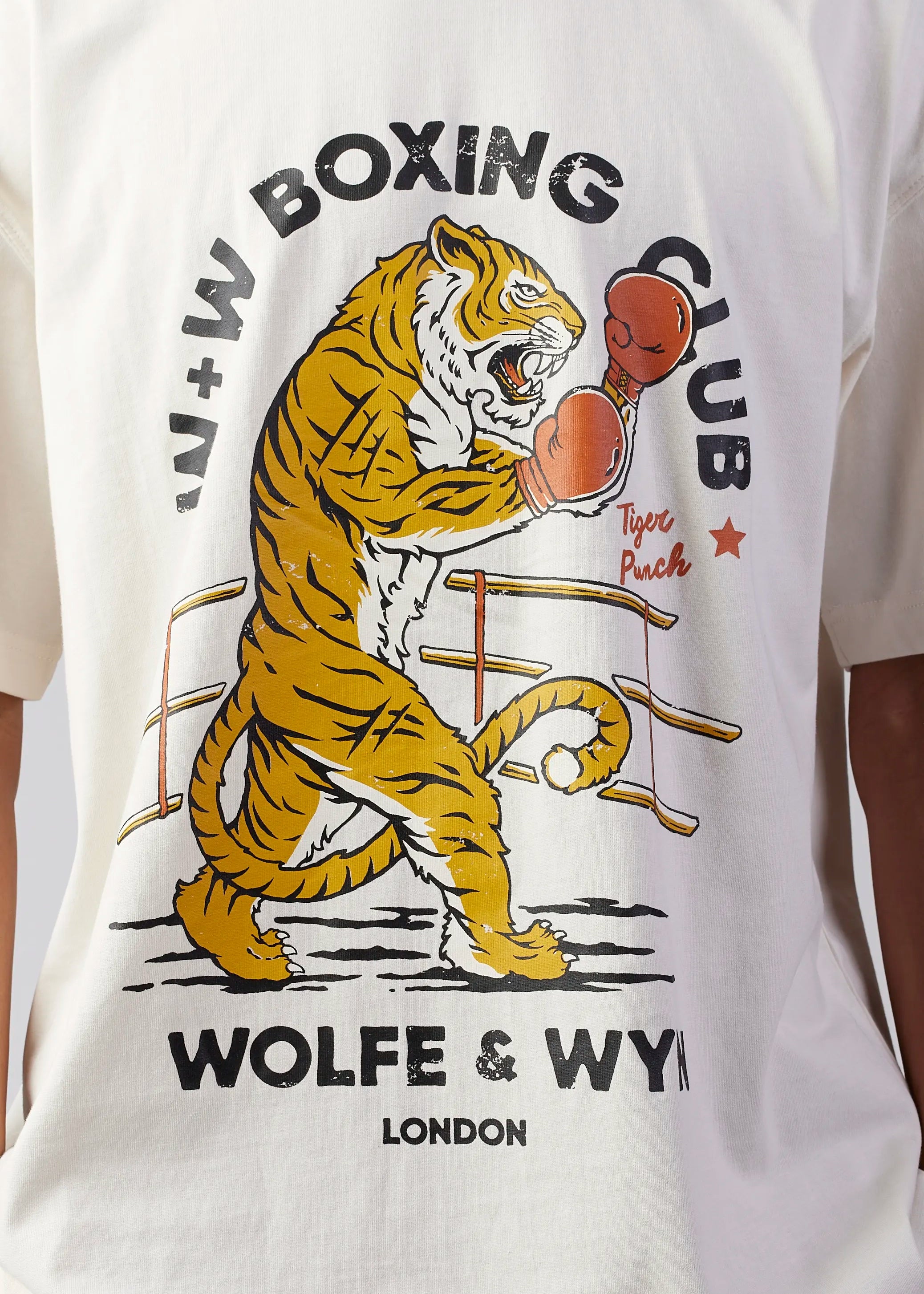 White t-shirt with a tiger boxing graphic and 'Wolfe & Wy' branding.