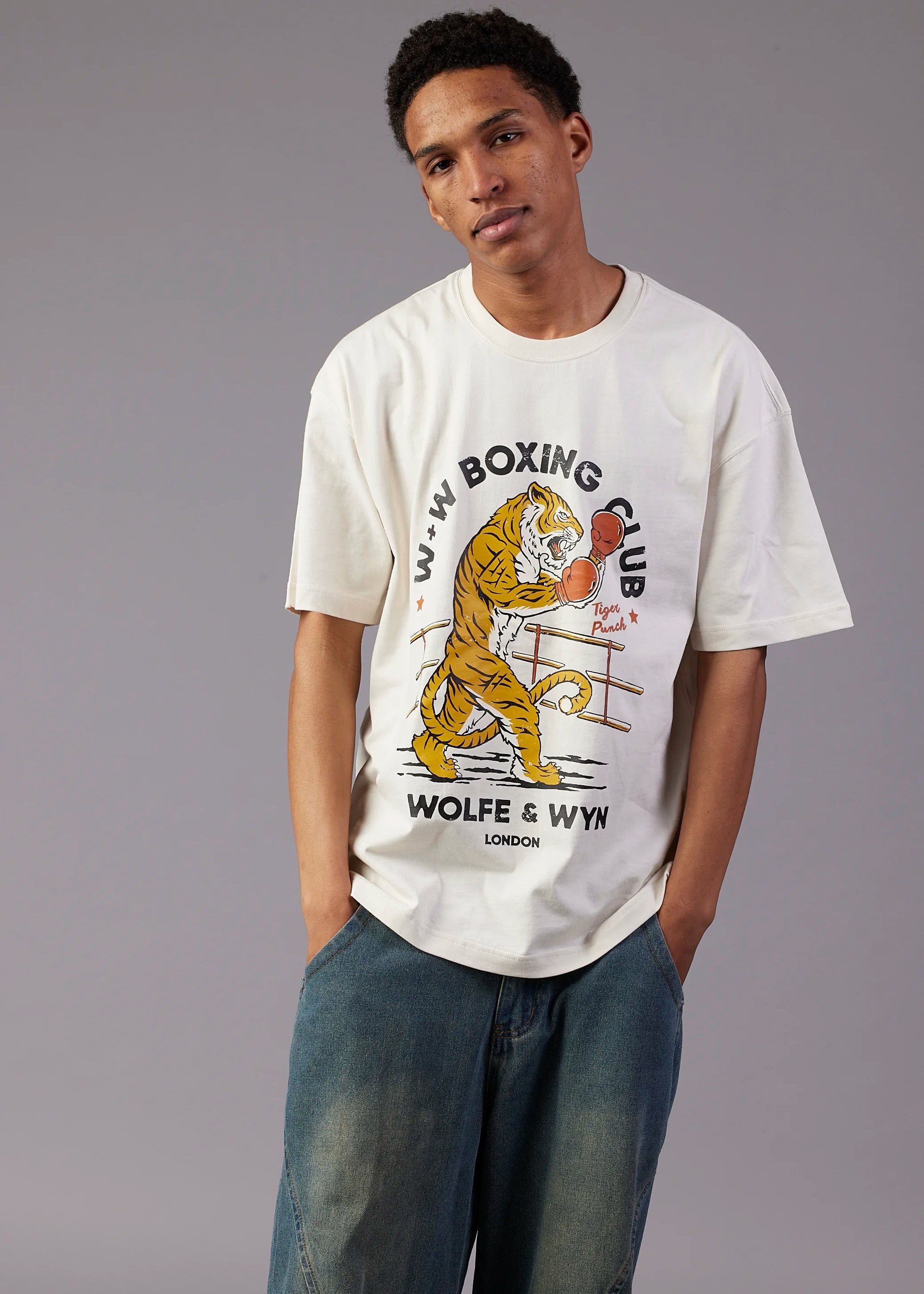 Person wearing a white t-shirt with a boxing-themed graphic and text.