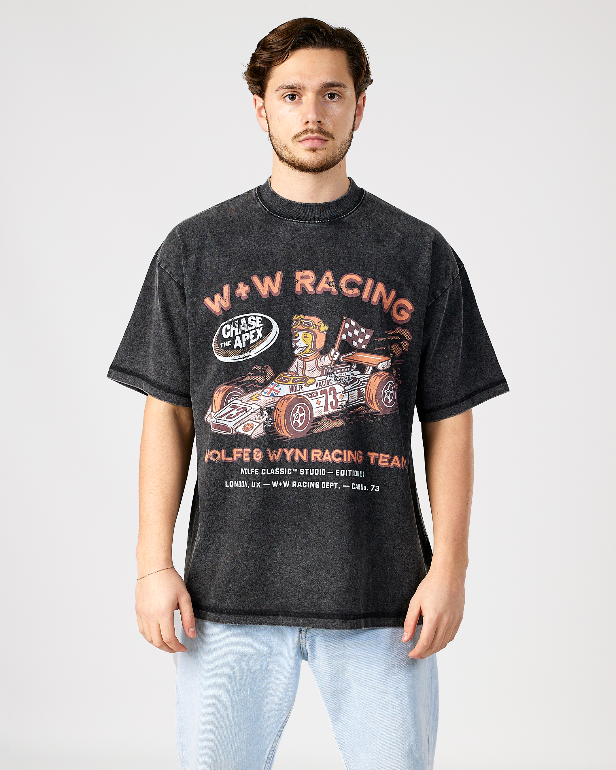 model wearing a black t-shirt with racing graphic and text on a white background