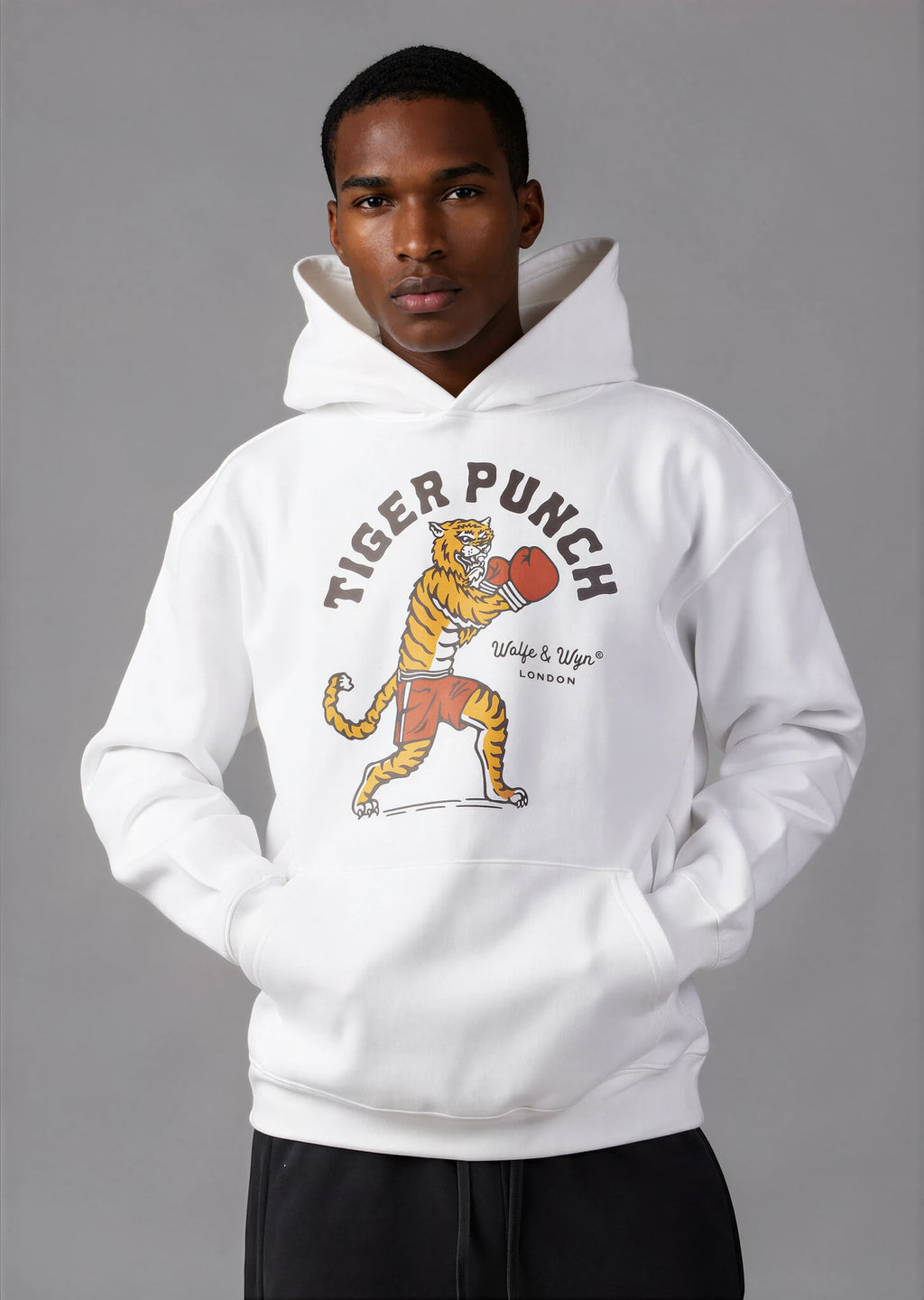 Person wearing a white hoodie with a tiger拳 graphic design on a gray background